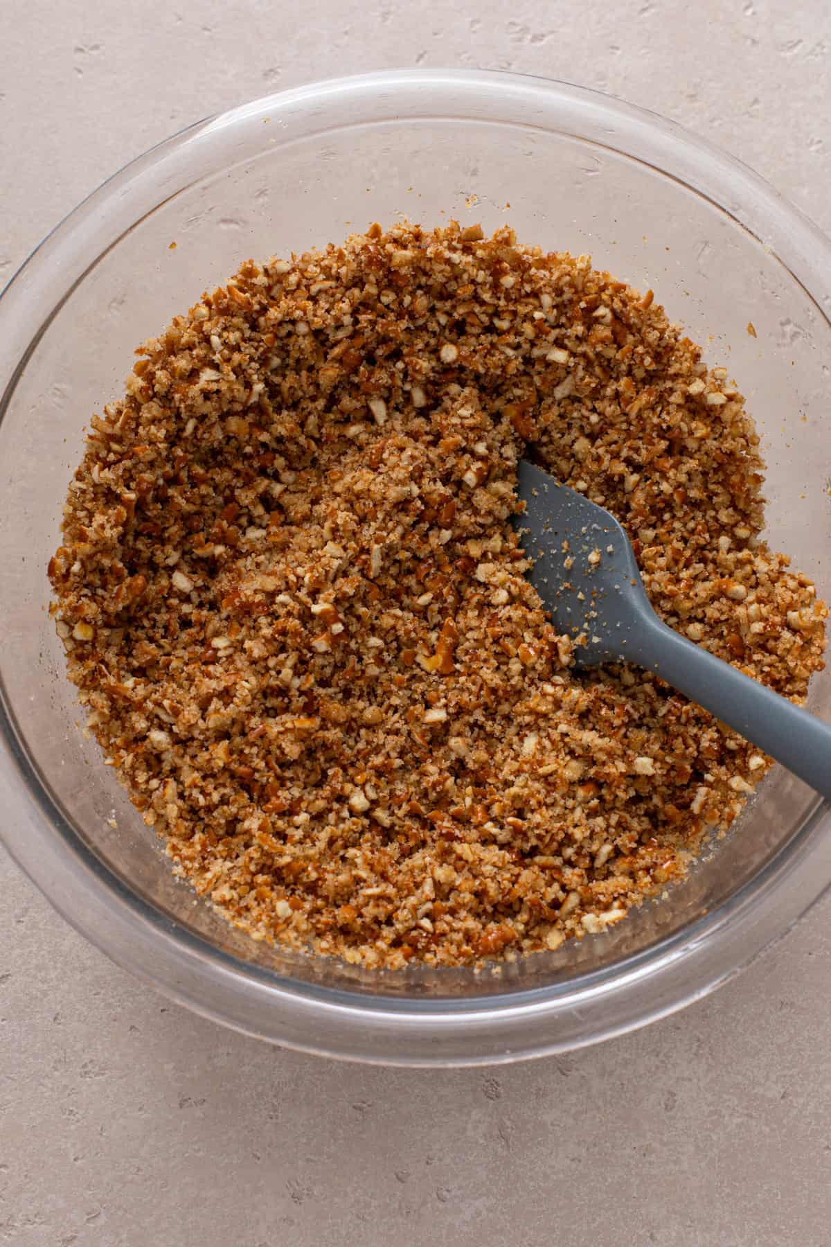 Pretzel crust ingredients being mixed in a glass bowl.