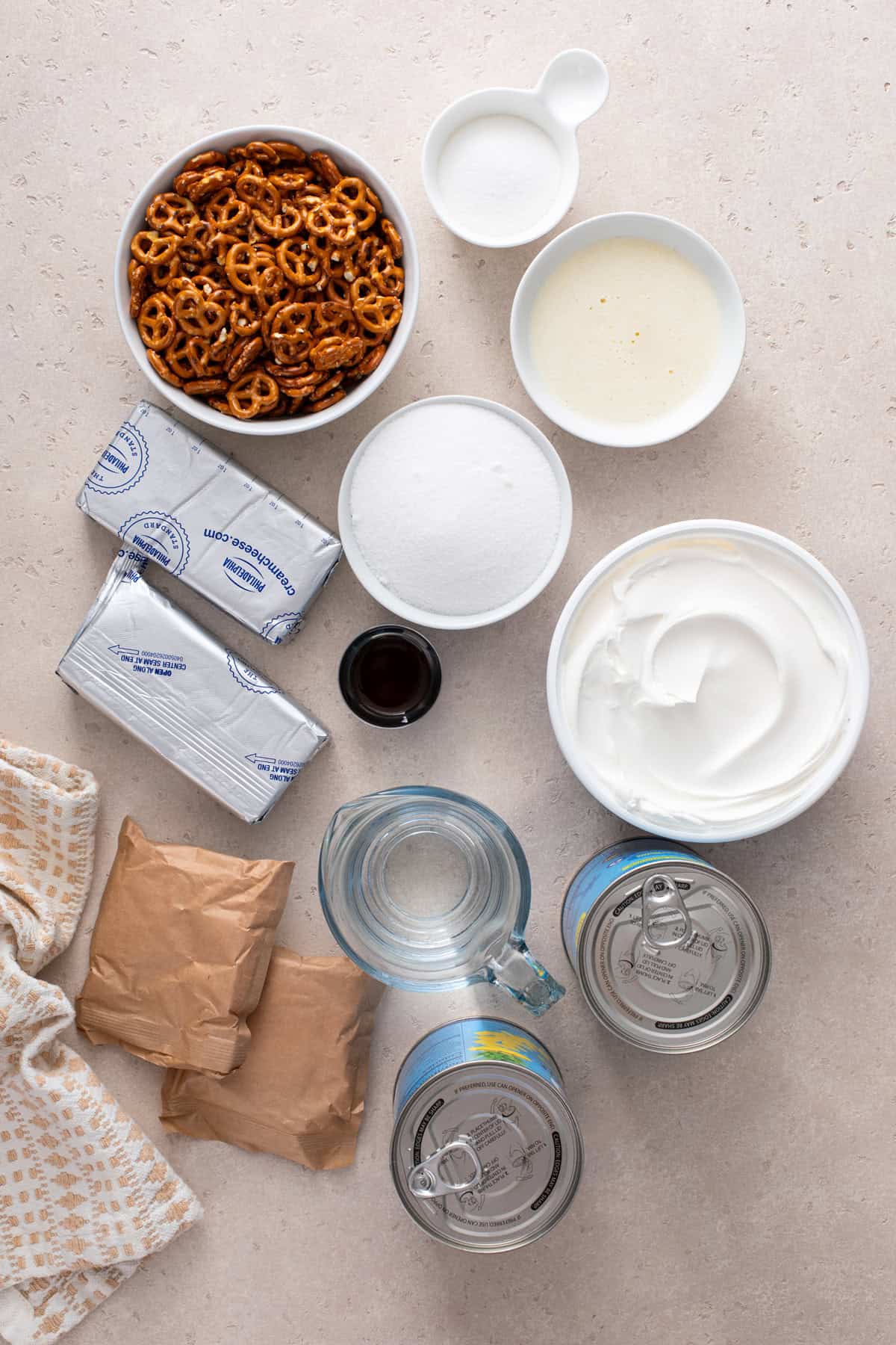 Ingredients for pineapple pretzel salad arranged on a countertop.